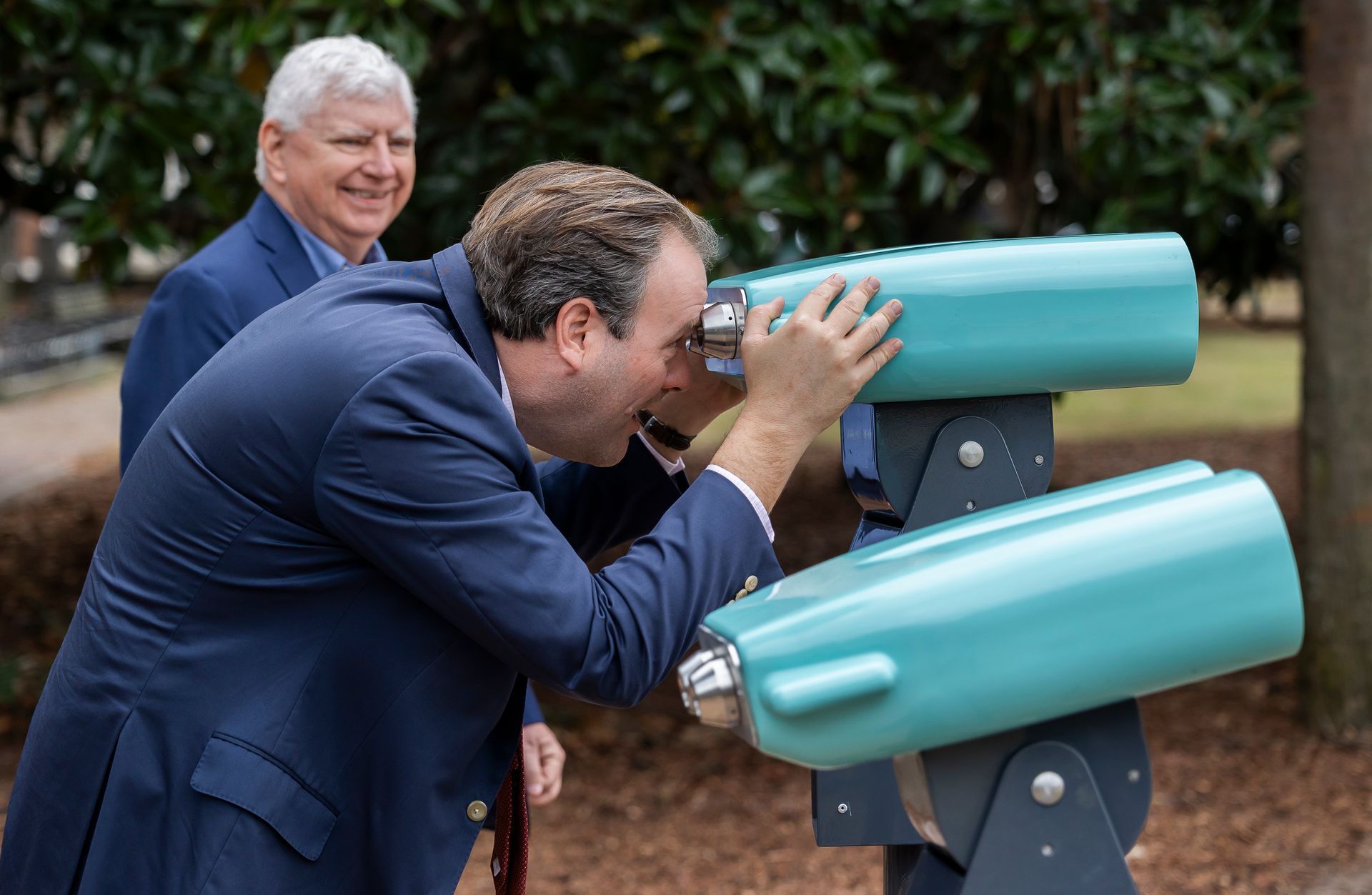 SCPBT CEO Rick Wise looks on as Charleston Mayor Cogswell tests the augmented reality binoculars.