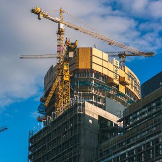 A building under construction with a crane on top of it