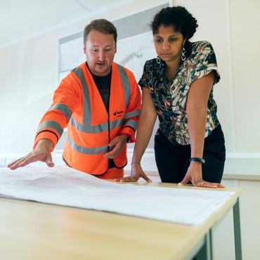 A man and a woman are looking at a piece of paper
