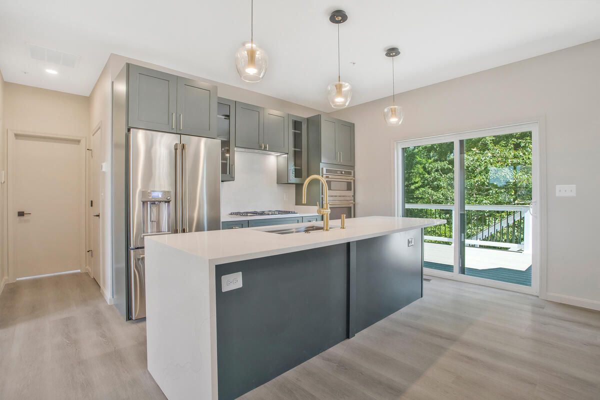 A kitchen with stainless steel appliances and a large island.