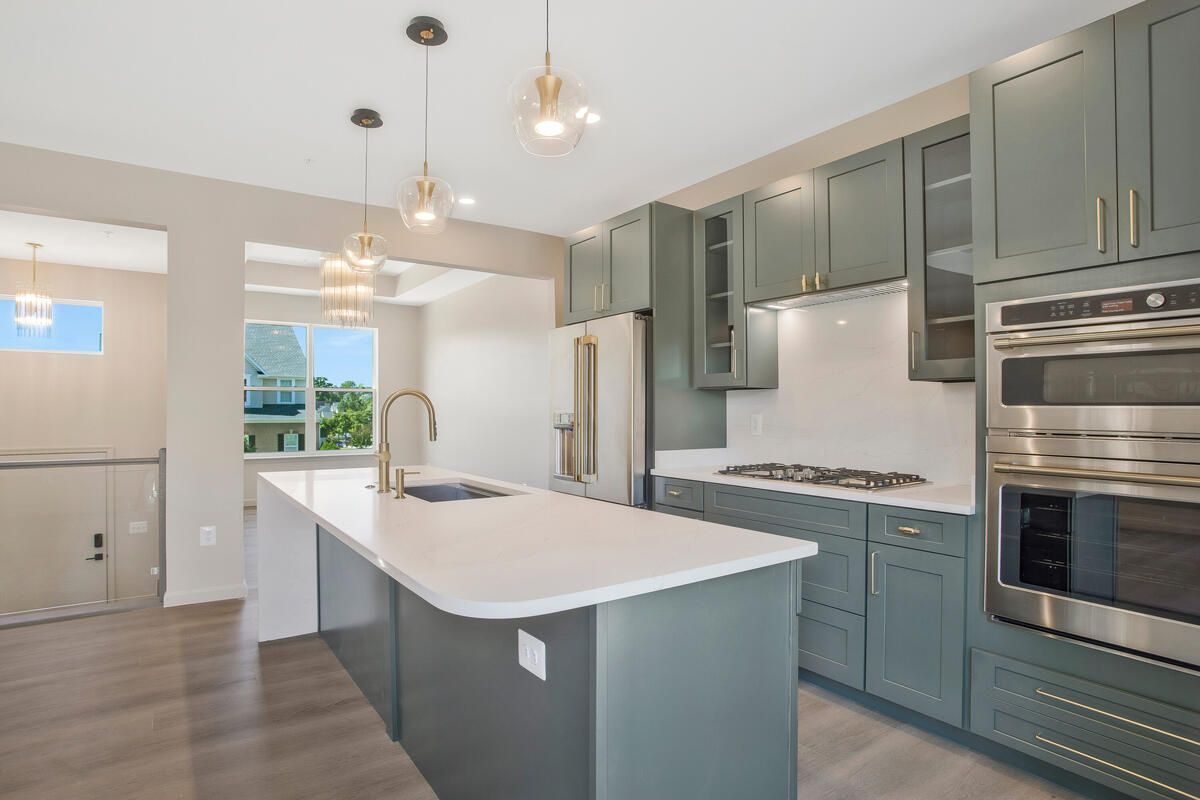 A kitchen with a large island and stainless steel appliances.