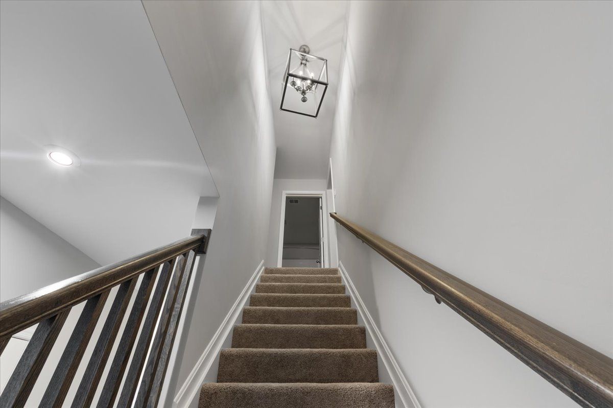 A set of stairs leading up to the second floor of a house.