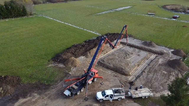 An aerial view of a construction site with a truck and a crane.