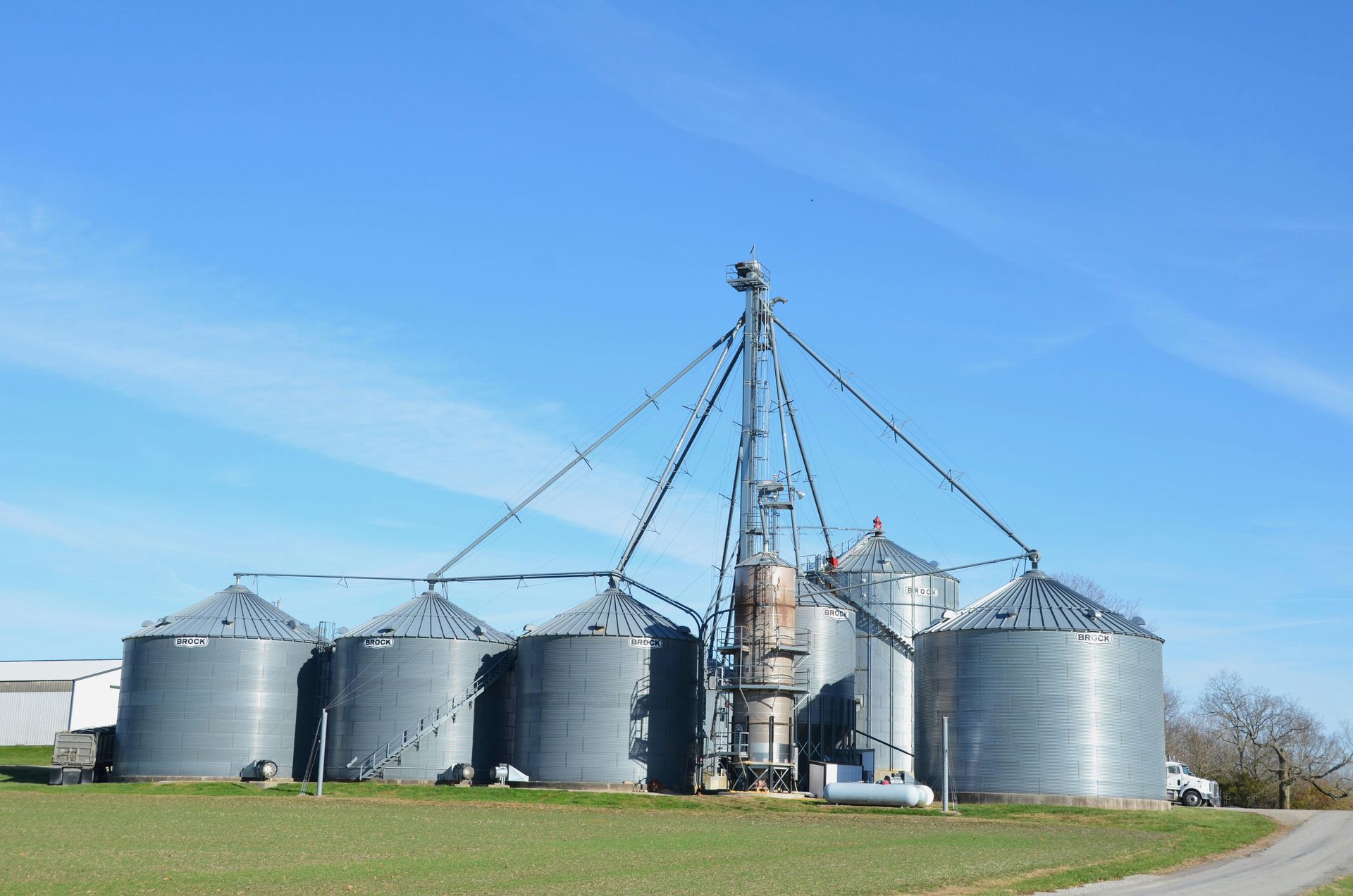 Empty, well-lit parking garage with painted arrow, support columns, and overhead lights.