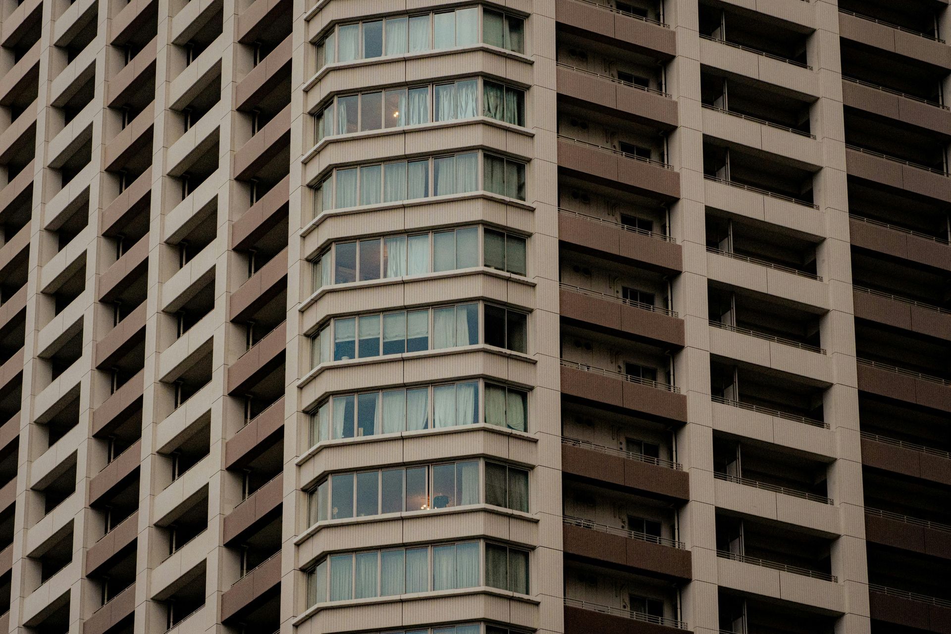 Empty, well-lit parking garage with painted arrow, support columns, and overhead lights.