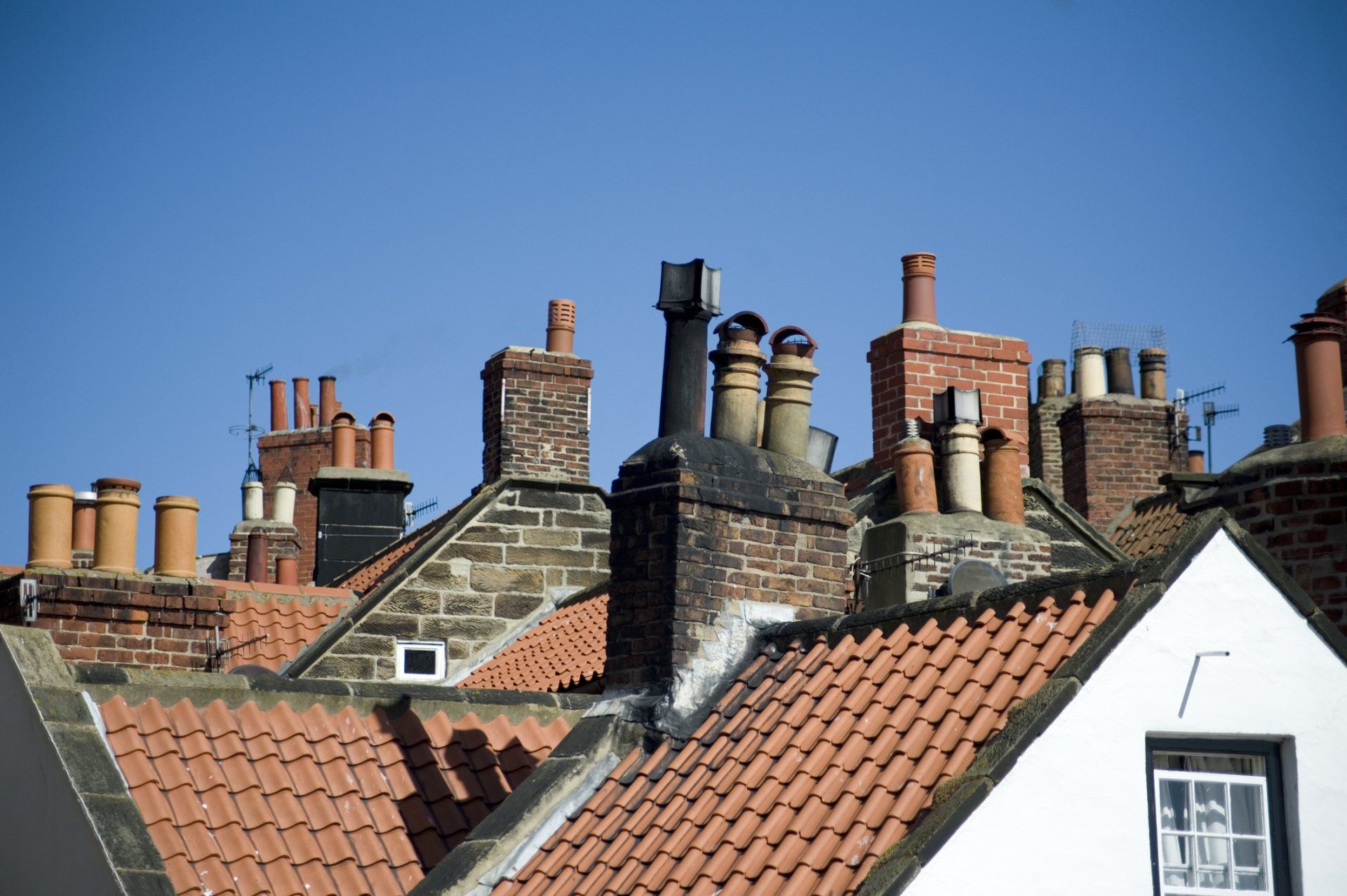 Chimney Pots — Rooftop View of a Variety of Different Chimney in Madison, Wisconsin