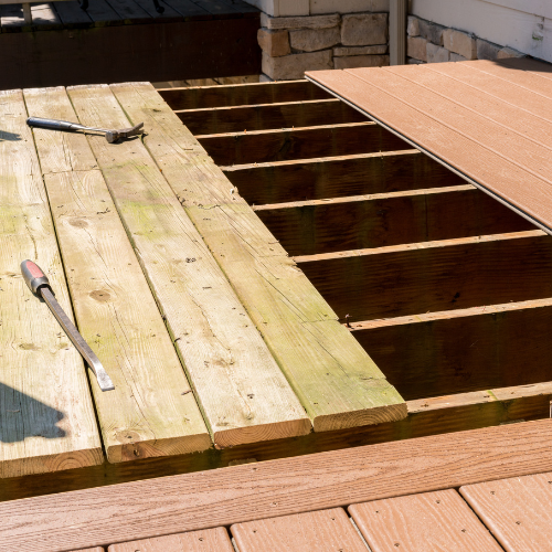A wooden deck with a hammer and chisel on it