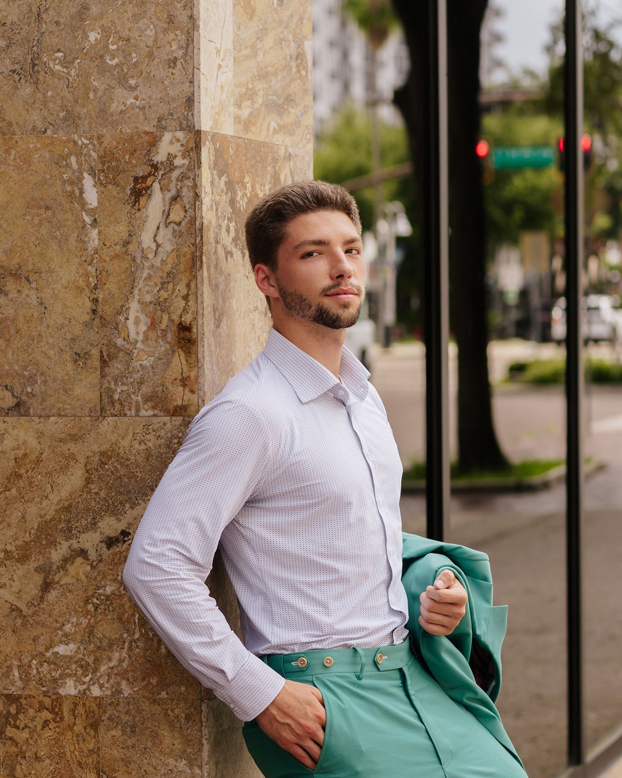 A man is walking through a parking garage holding a briefcase.