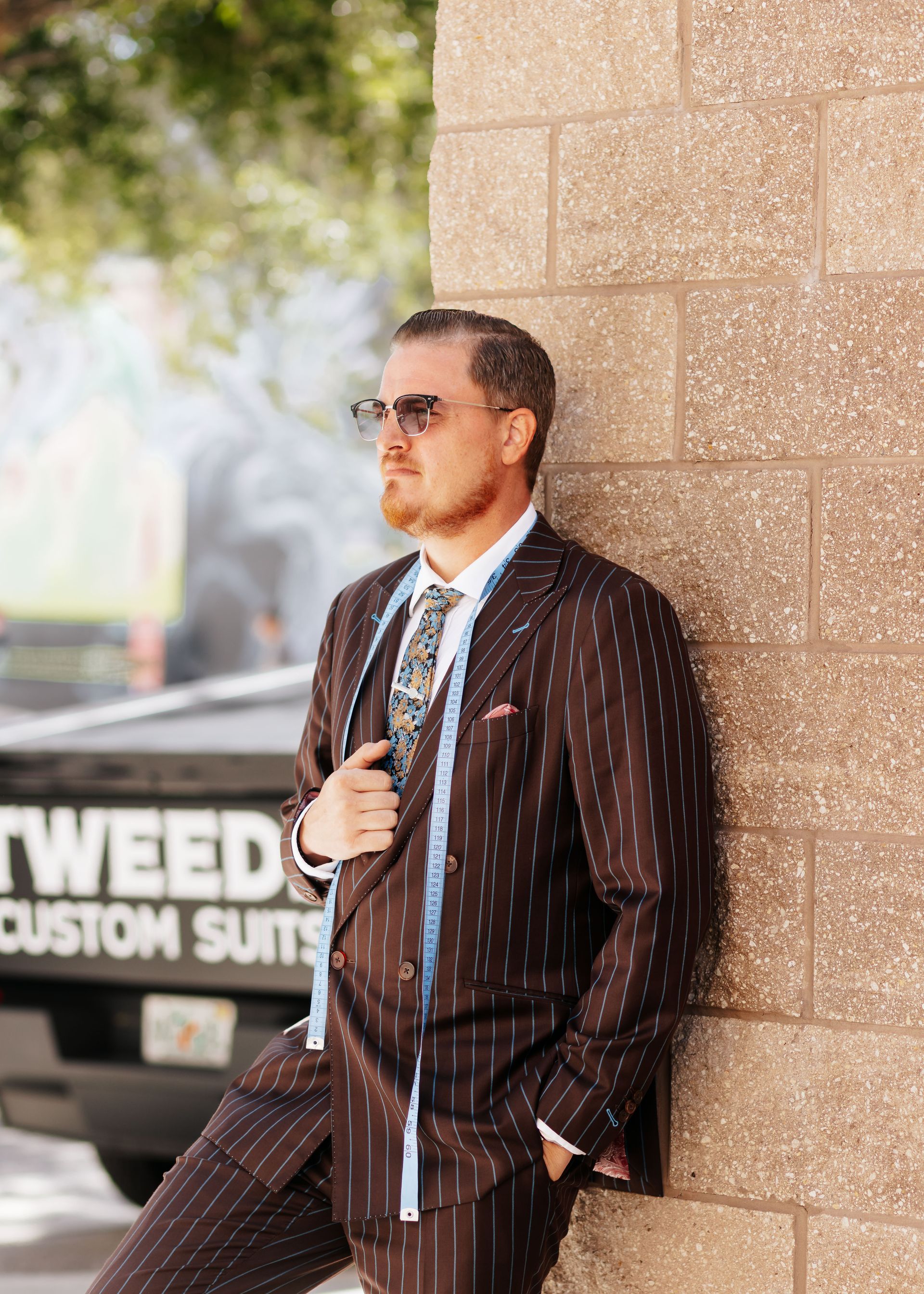 A man is walking through a parking garage holding a briefcase.