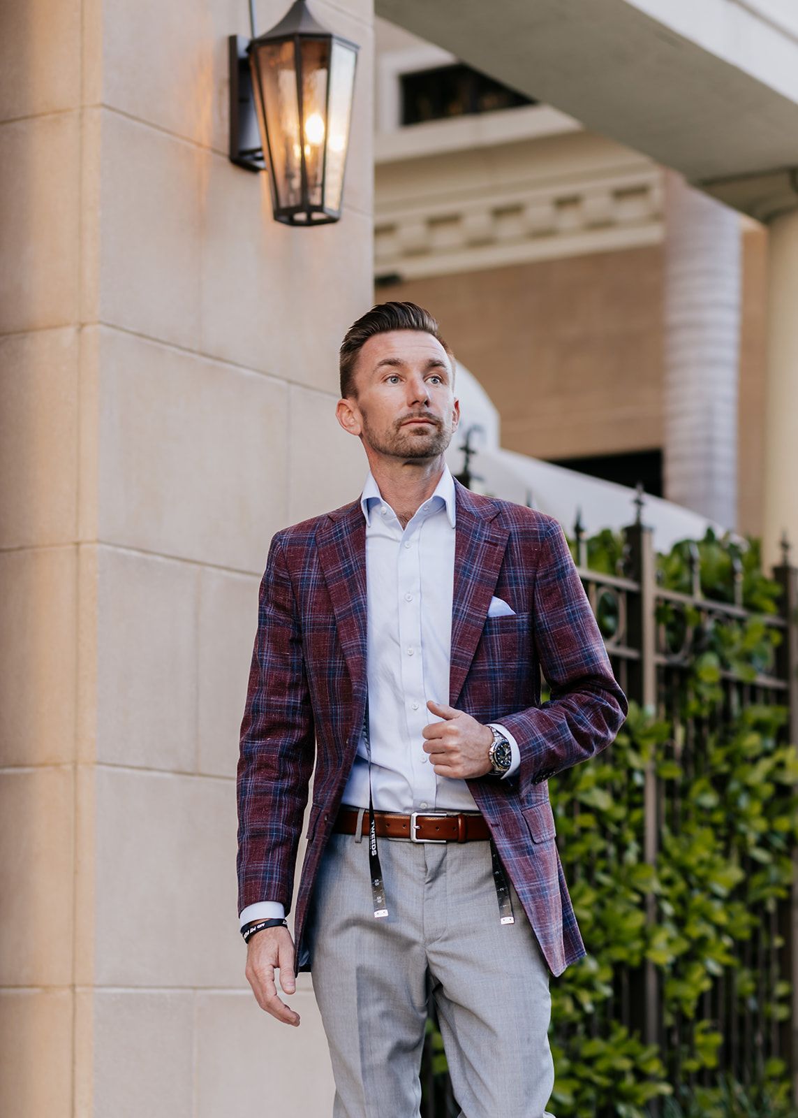 A man is walking through a parking garage holding a briefcase.