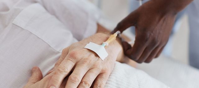 Nurse setting up an IV drip