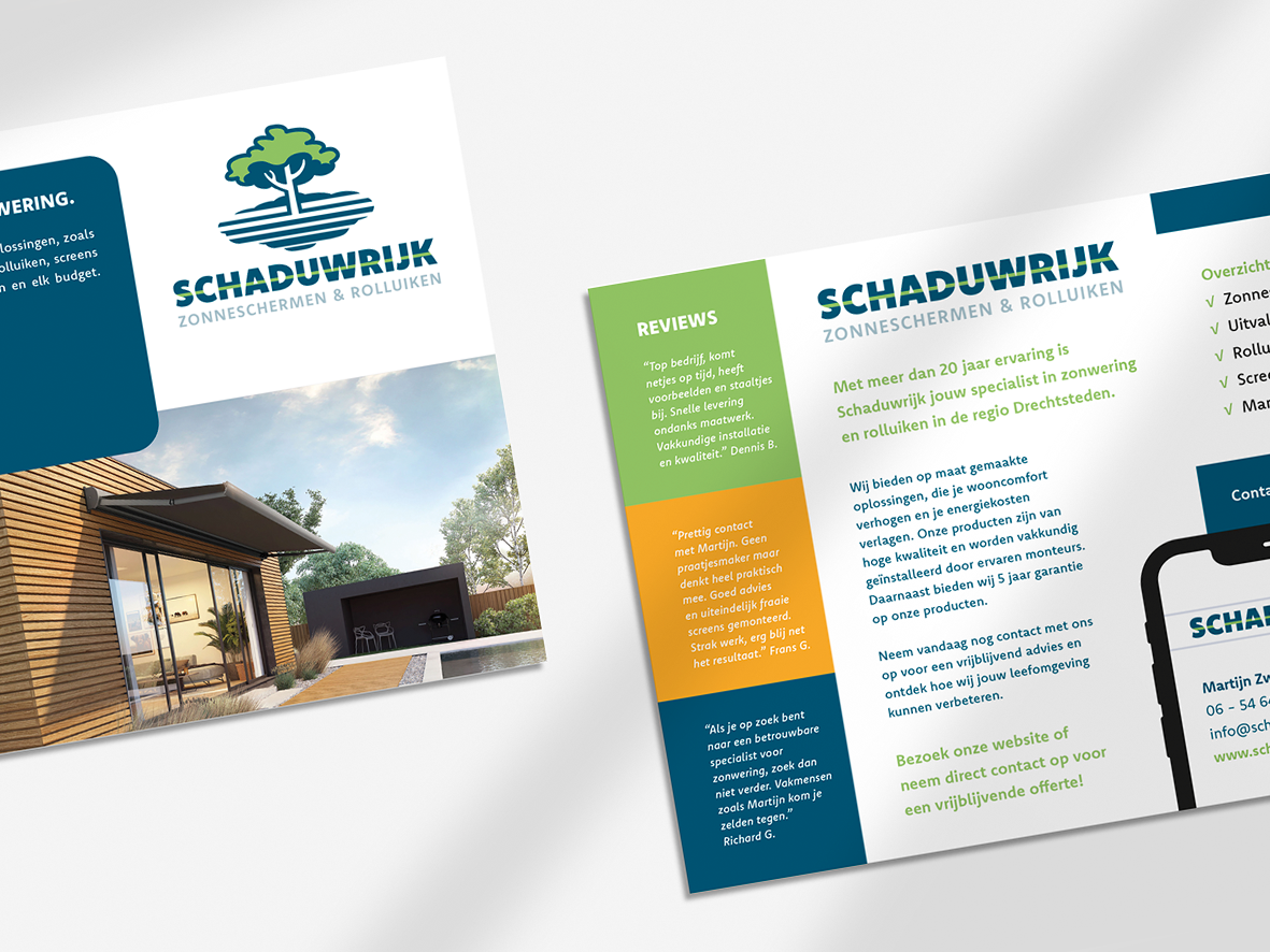 Een brochure met een afbeelding van een huis en een telefoon op een tafel.