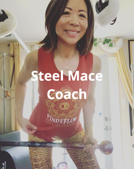 Woman holding steel mace, wearing red shirt that says 