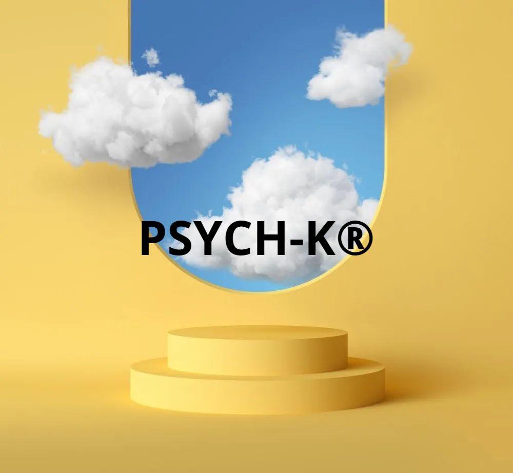 Yellow stage with PSYCH-K® text; blue sky backdrop with clouds.