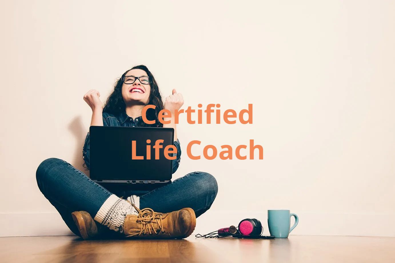 Woman with glasses, laptop, and coffee mug, celebrating. Text: Certified Life Coach.