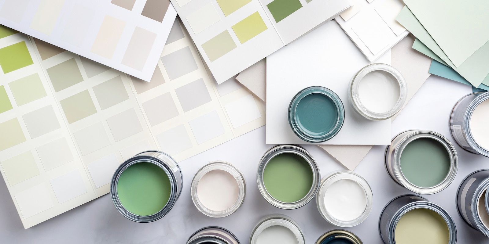 Paint cans in various green and white shades with color swatches.
