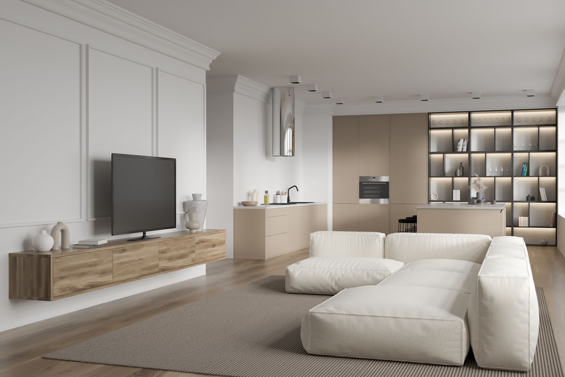 Modern living space with a white sectional sofa, open kitchen, and TV.