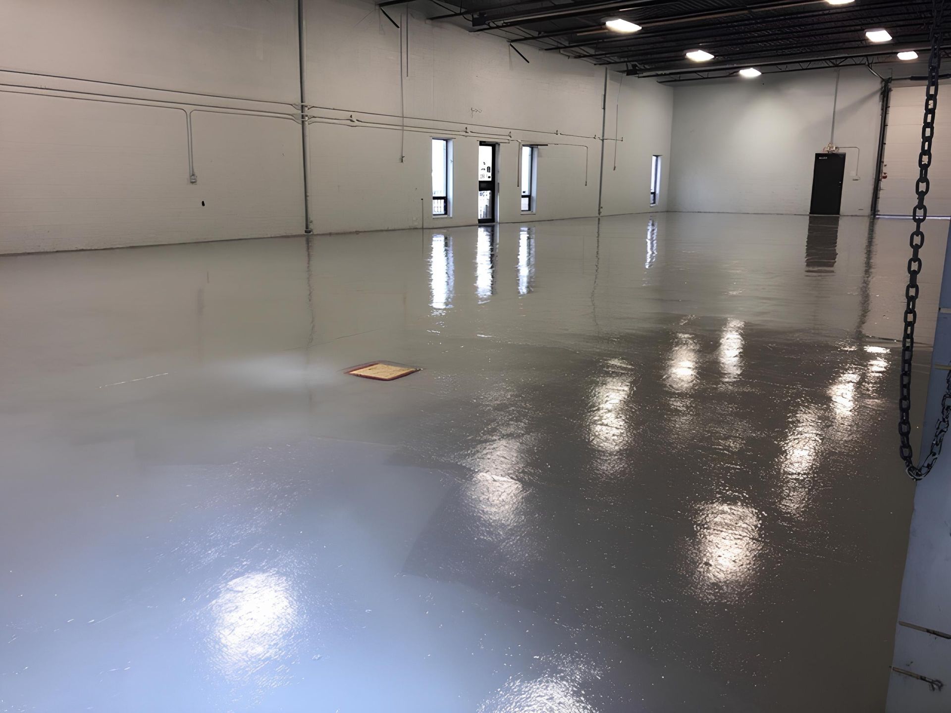 A large room with a gray floor and white walls