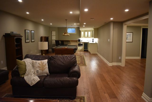 A living room with a couch and a pool table