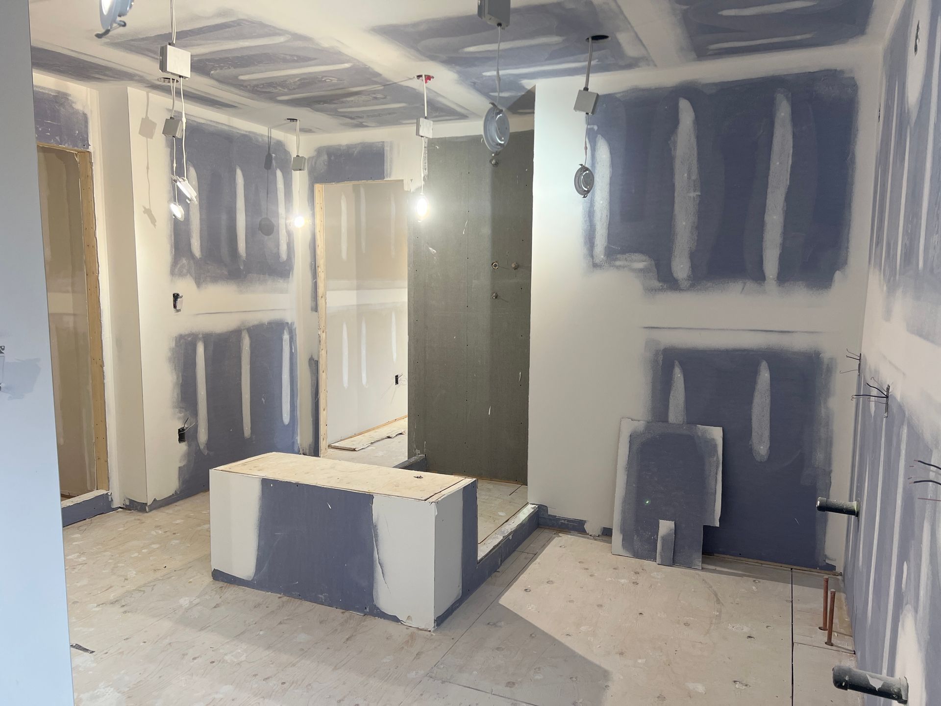 A room that is being remodeled with drywall on the walls