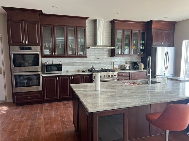 A kitchen with stainless steel appliances and wooden cabinets