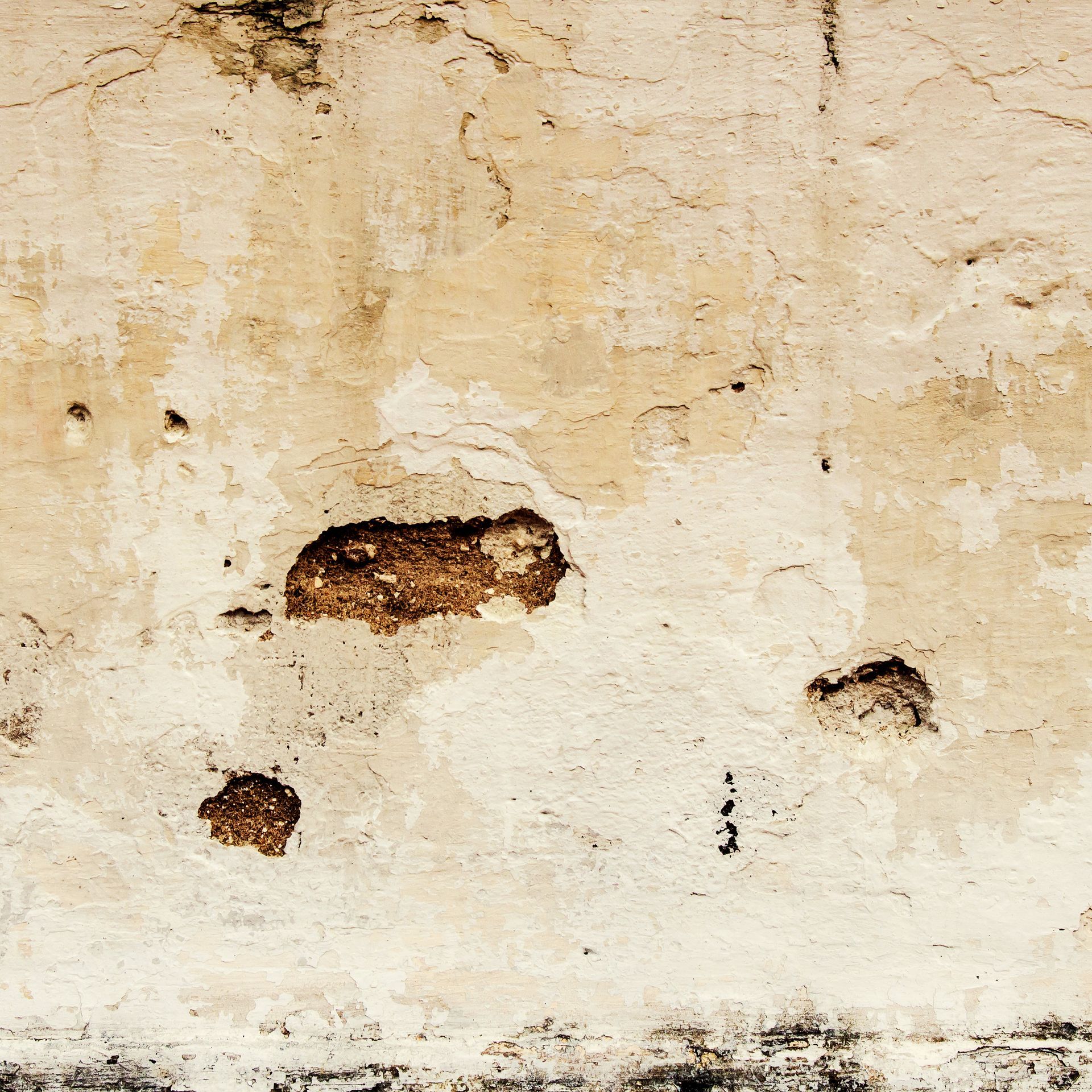 A close up of a wall with holes in it