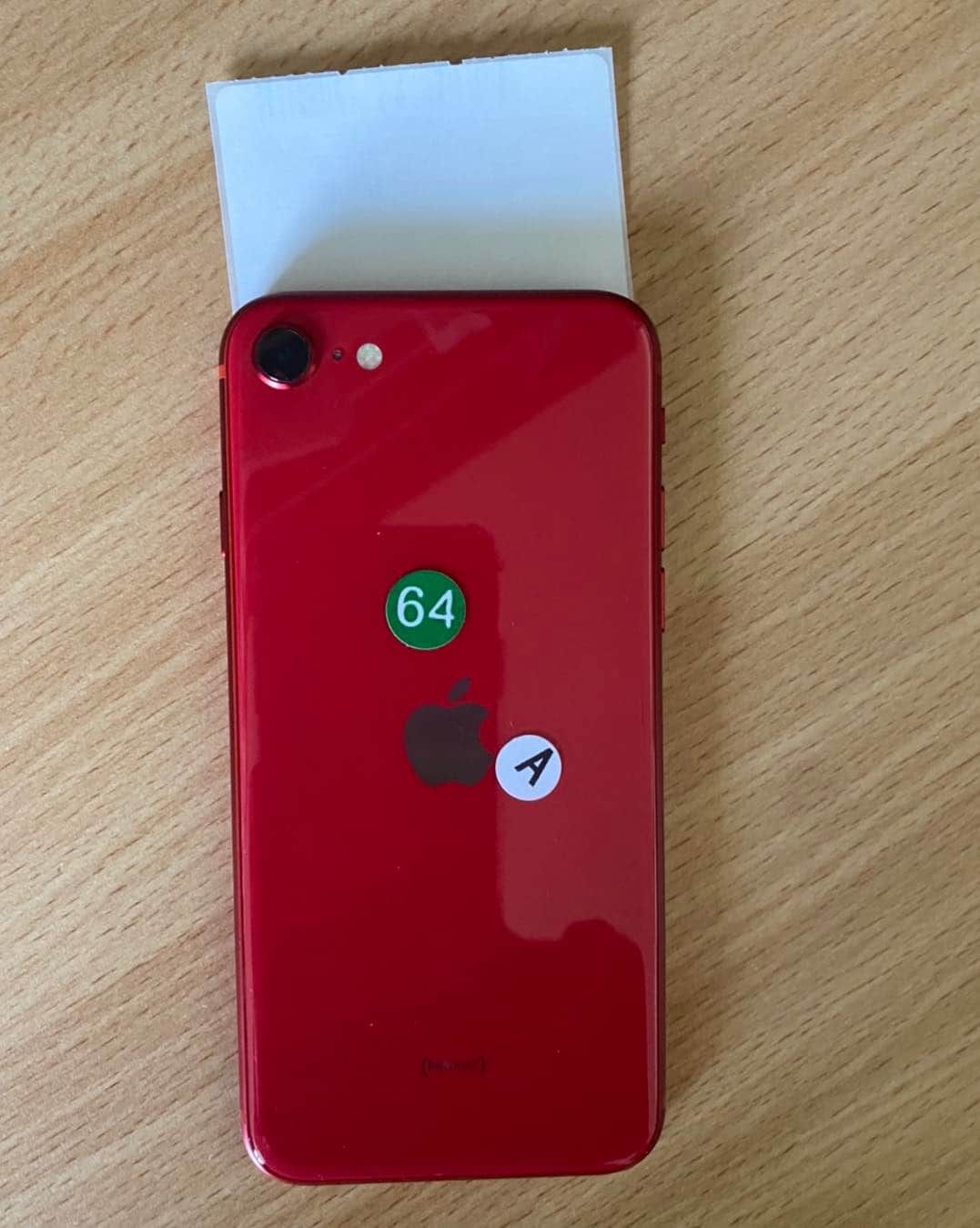 Red iPhone With Stickers, Partially Covered by White Paper — Flexicoms Communications in Ingham, QLD 