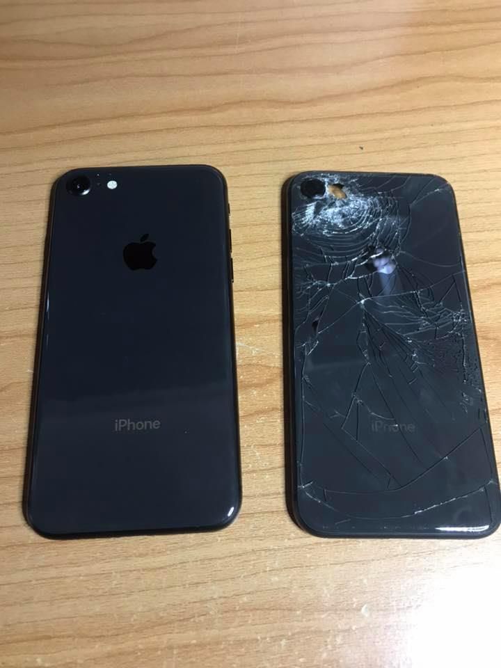 Two Black Iphones on a Wooden Surface. One is Undamaged — Flexicoms Communications in Ingham, QLD