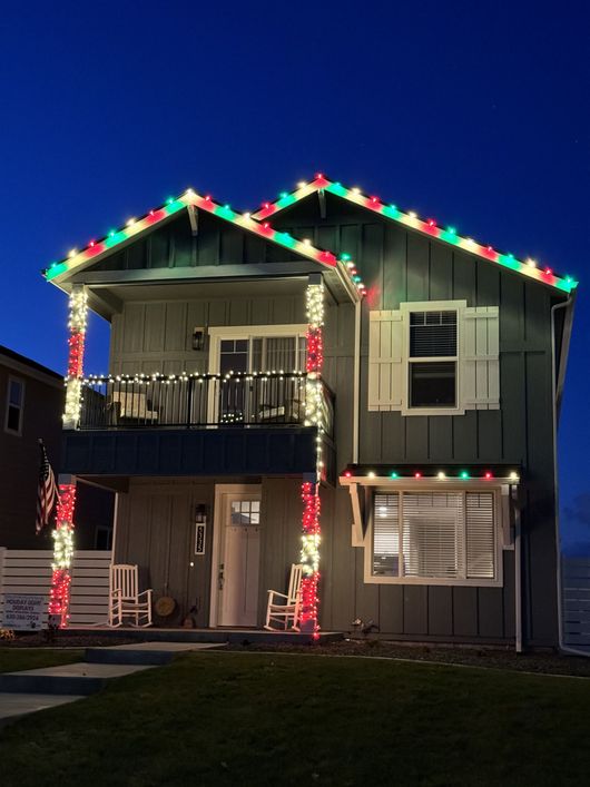 A house with christmas lights on it at night