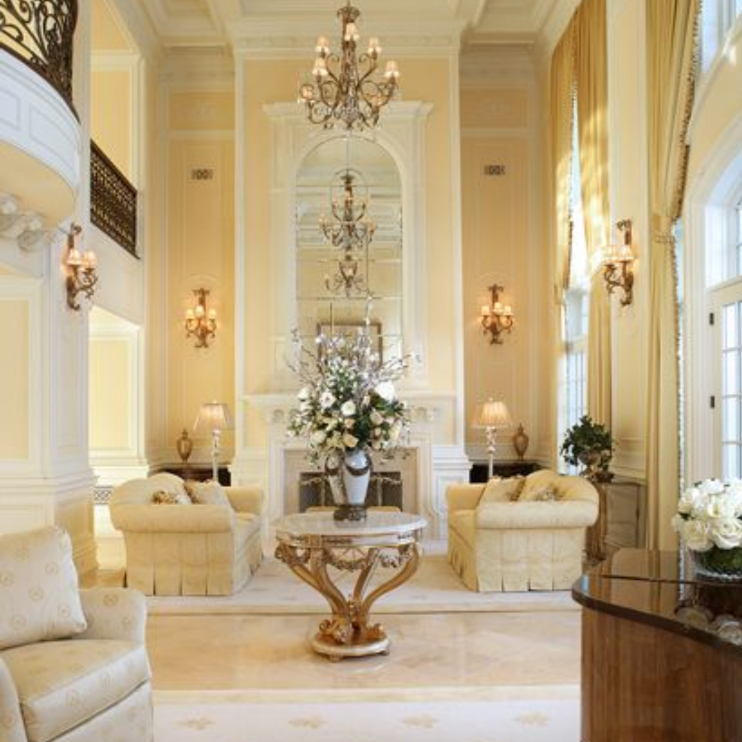 A living room filled with furniture and a table with flowers on it