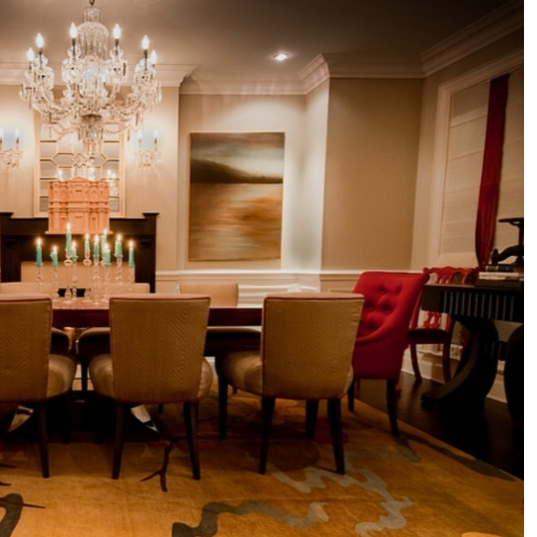 A dining room with a table and chairs and a chandelier