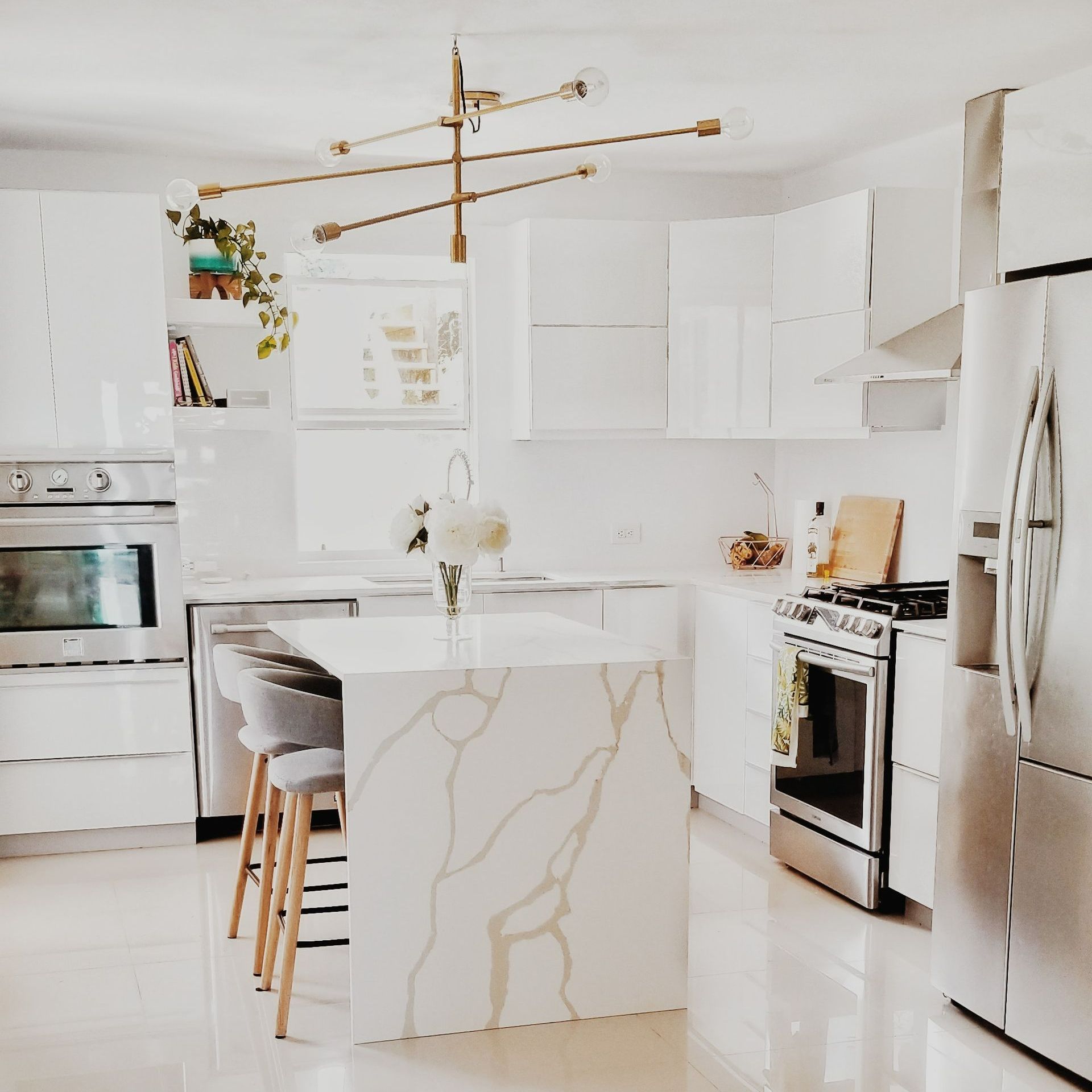 A kitchen with white cabinets and stainless steel appliances