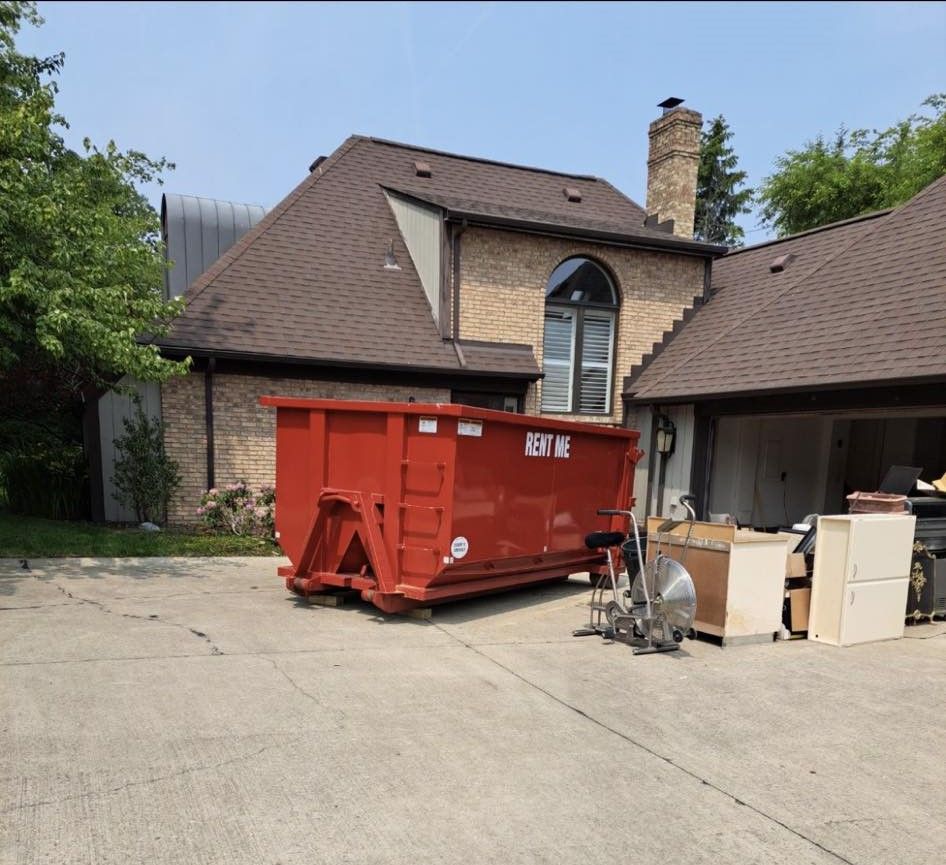 a large red dumpster is parked in front of a house