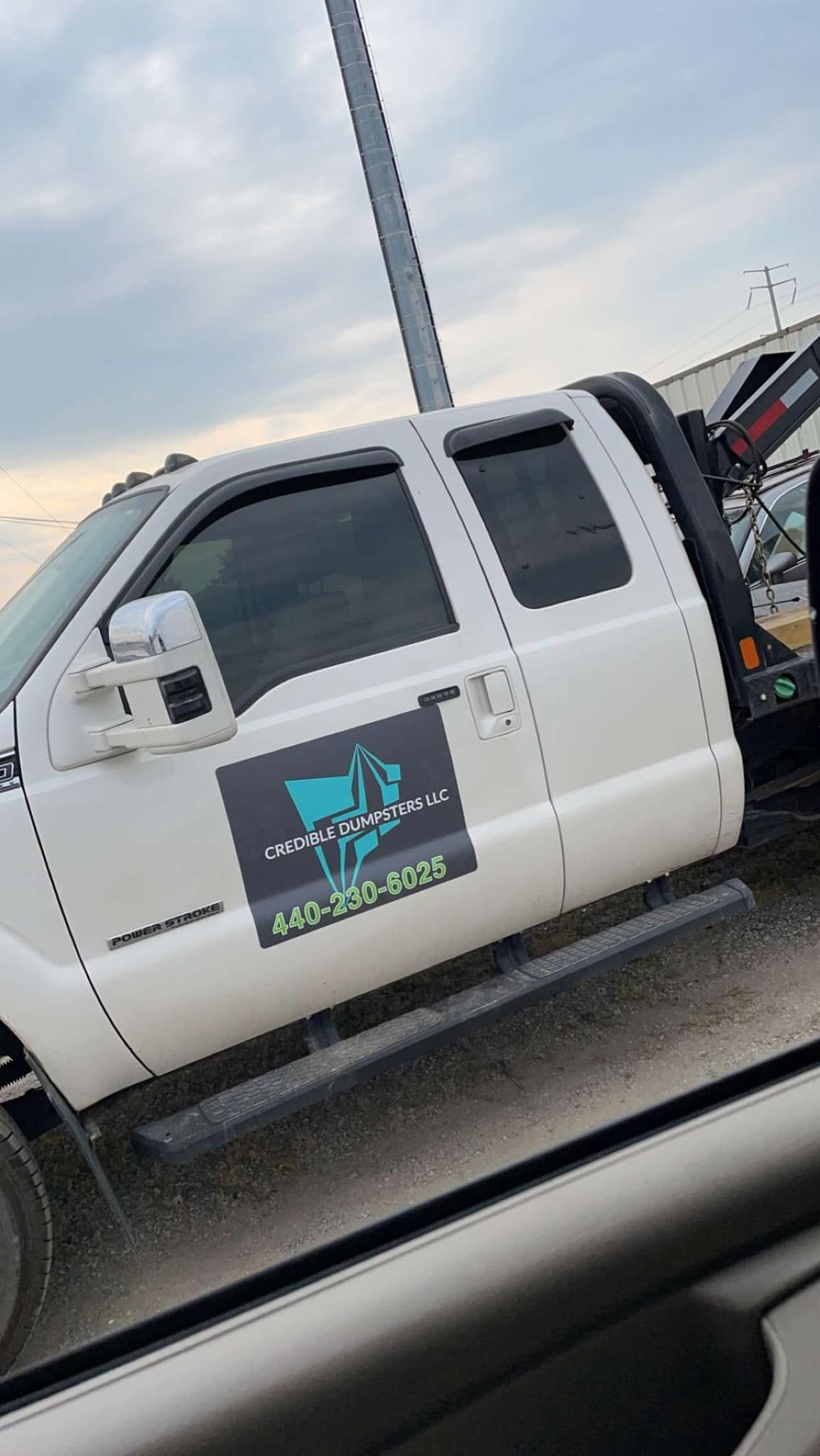 a white truck is parked on the side of the road .