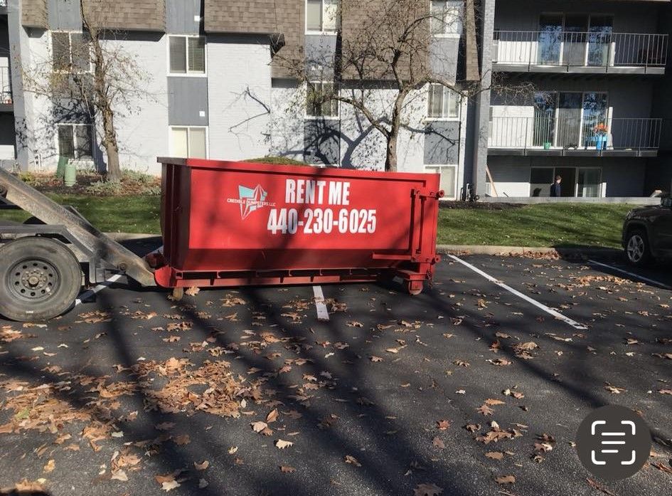 a red dumpster that says rent me on it