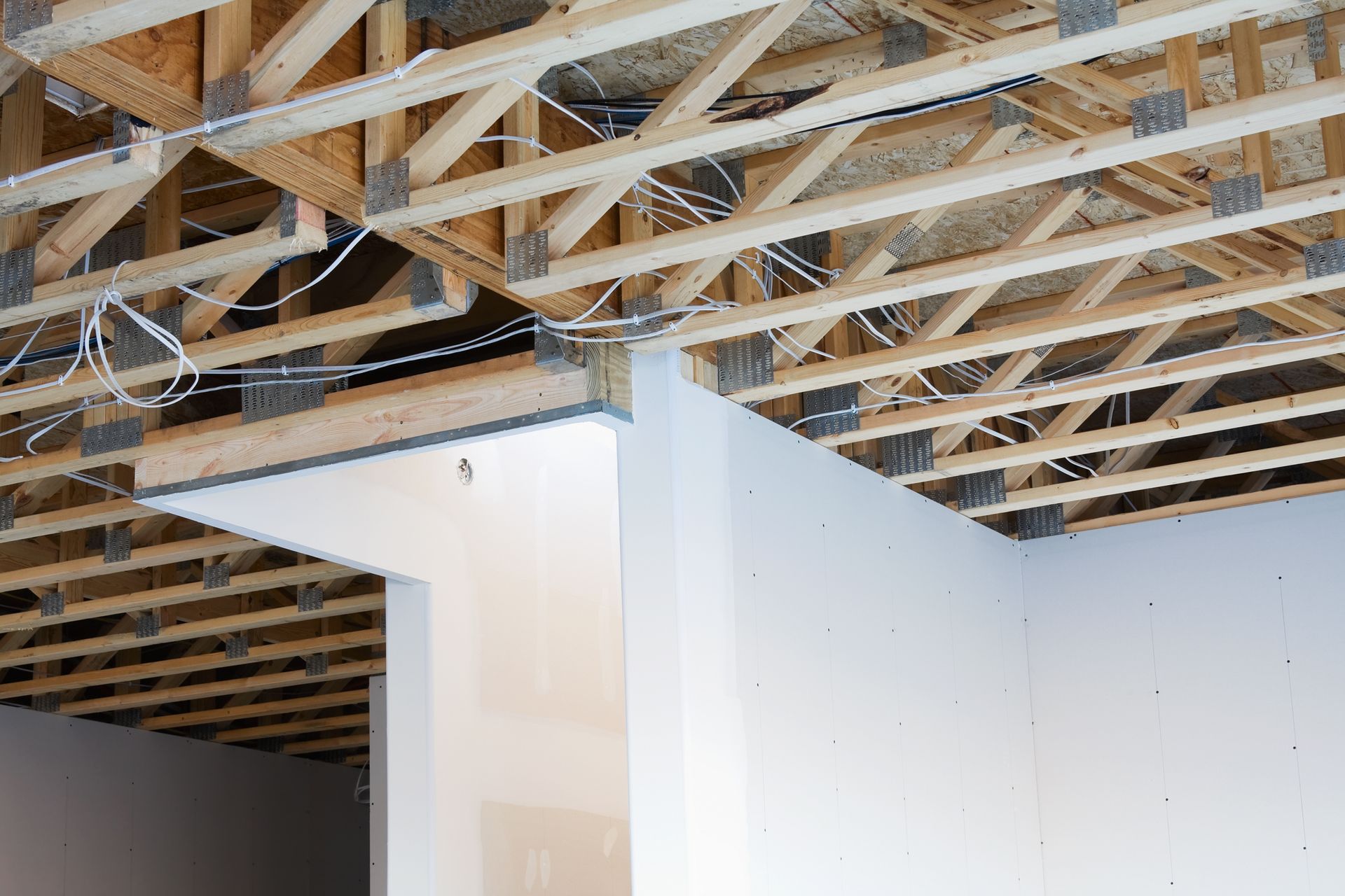The ceiling of a building under construction with wooden beams.