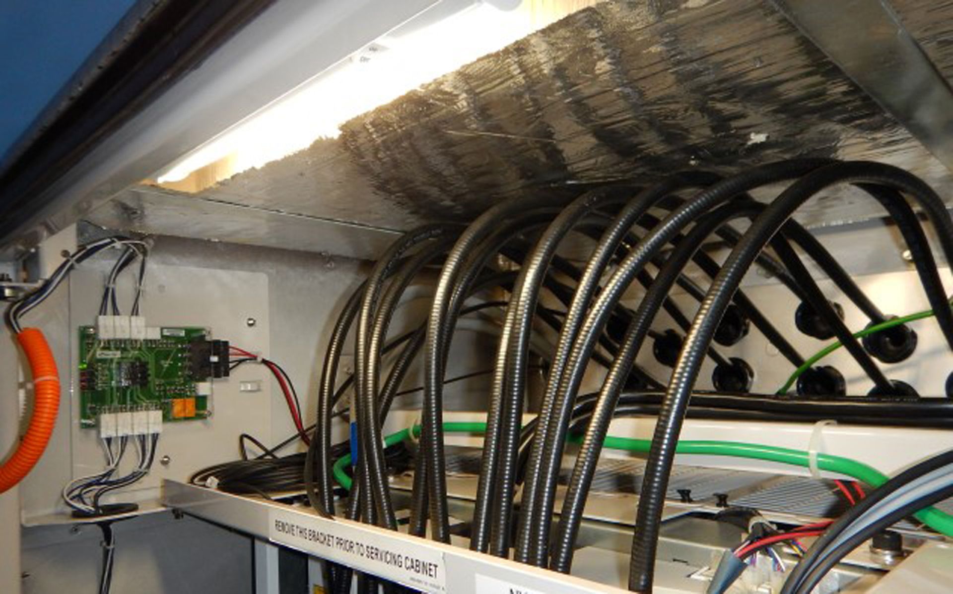 A bunch of wires are hanging from the ceiling