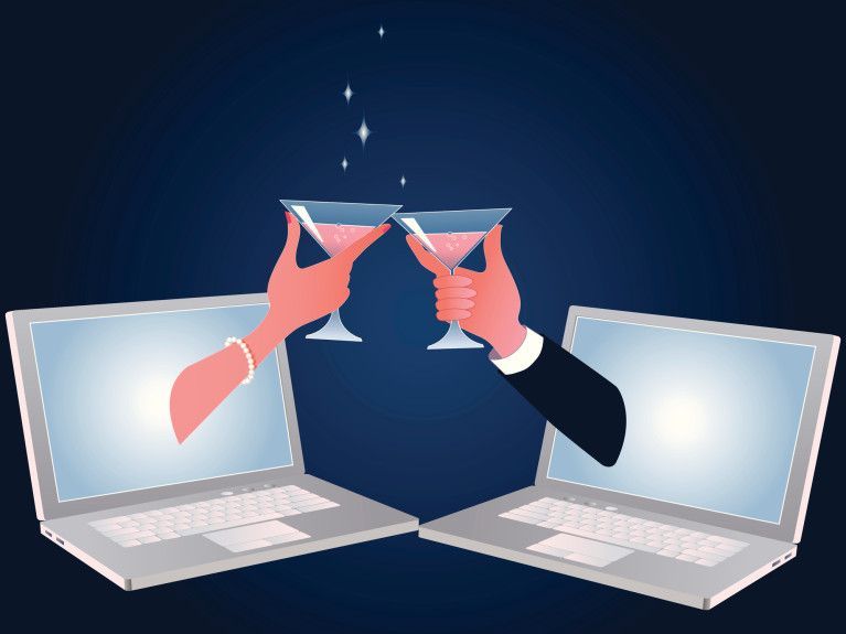 Two hands holding cocktail glasses, emerging from laptop screens, toasting against a dark blue background.