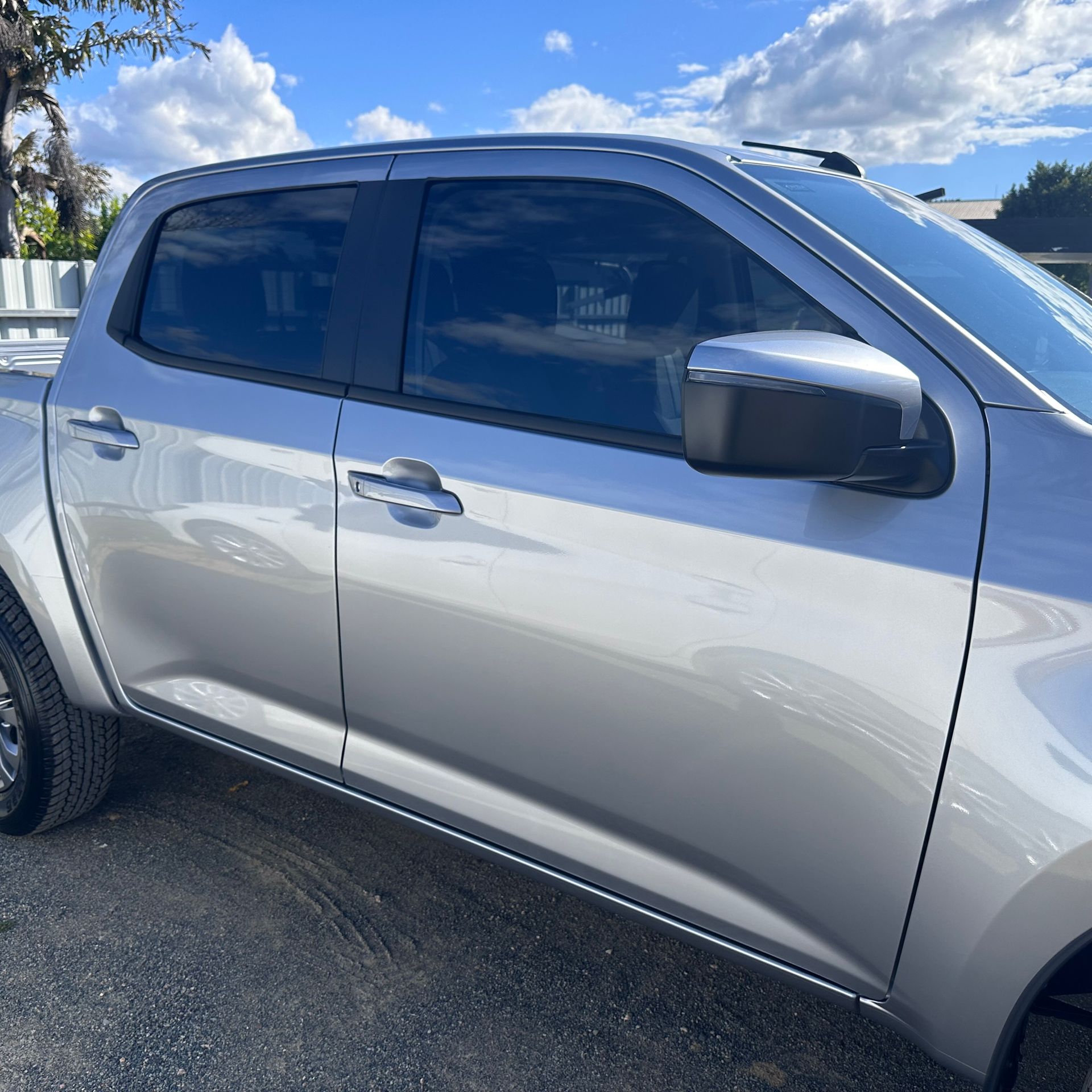 A silver pickup truck is parked on the side of the road — Global Signage In Ingham, QLD