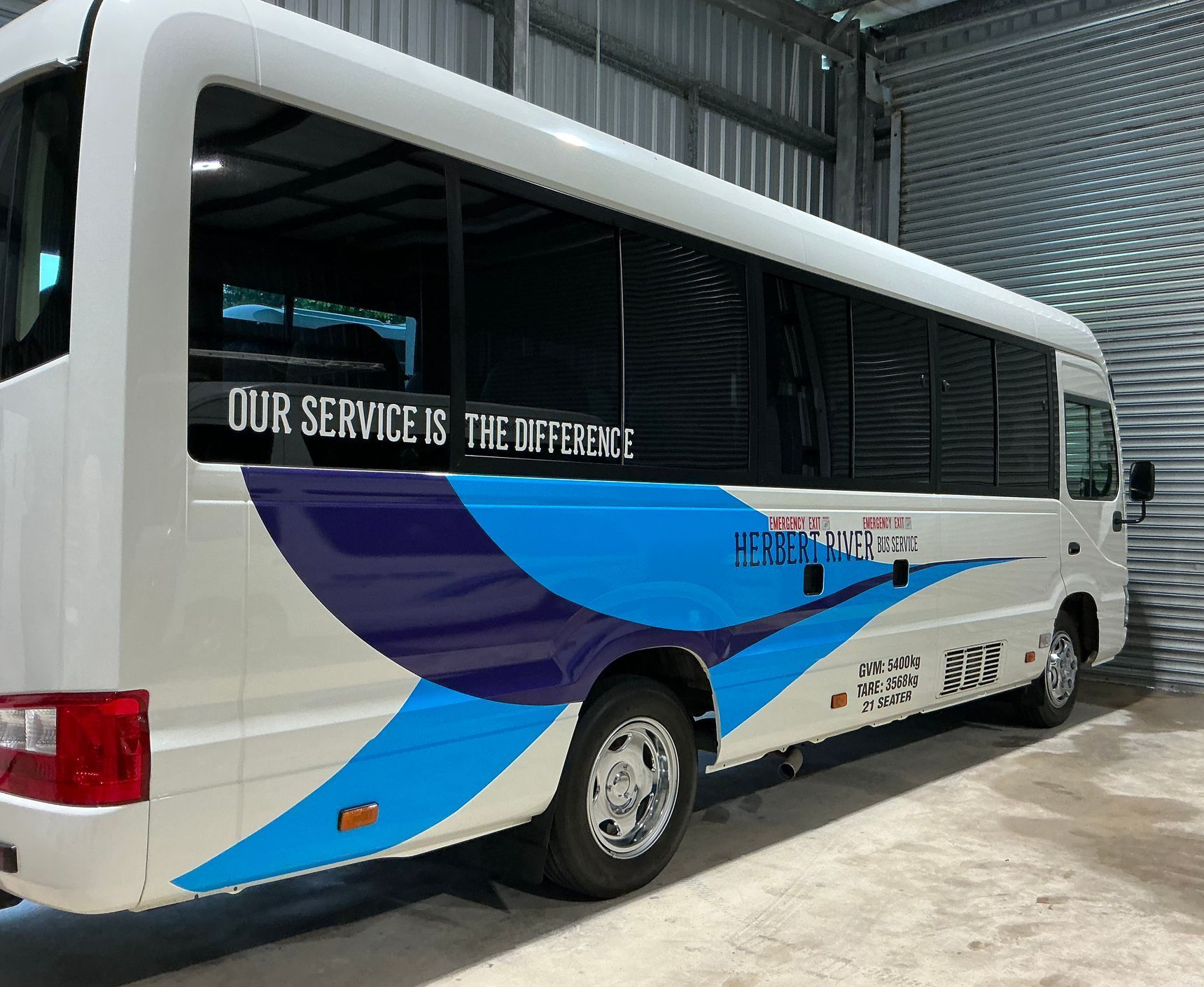 A White and Blue Bus With — Global Signage In Ingham, QLD