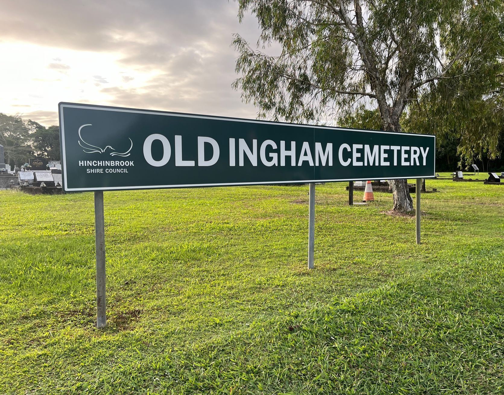 A sign for old ingham cemetery is sitting in the middle of a grassy field — Global Signage In Ingham, QLD