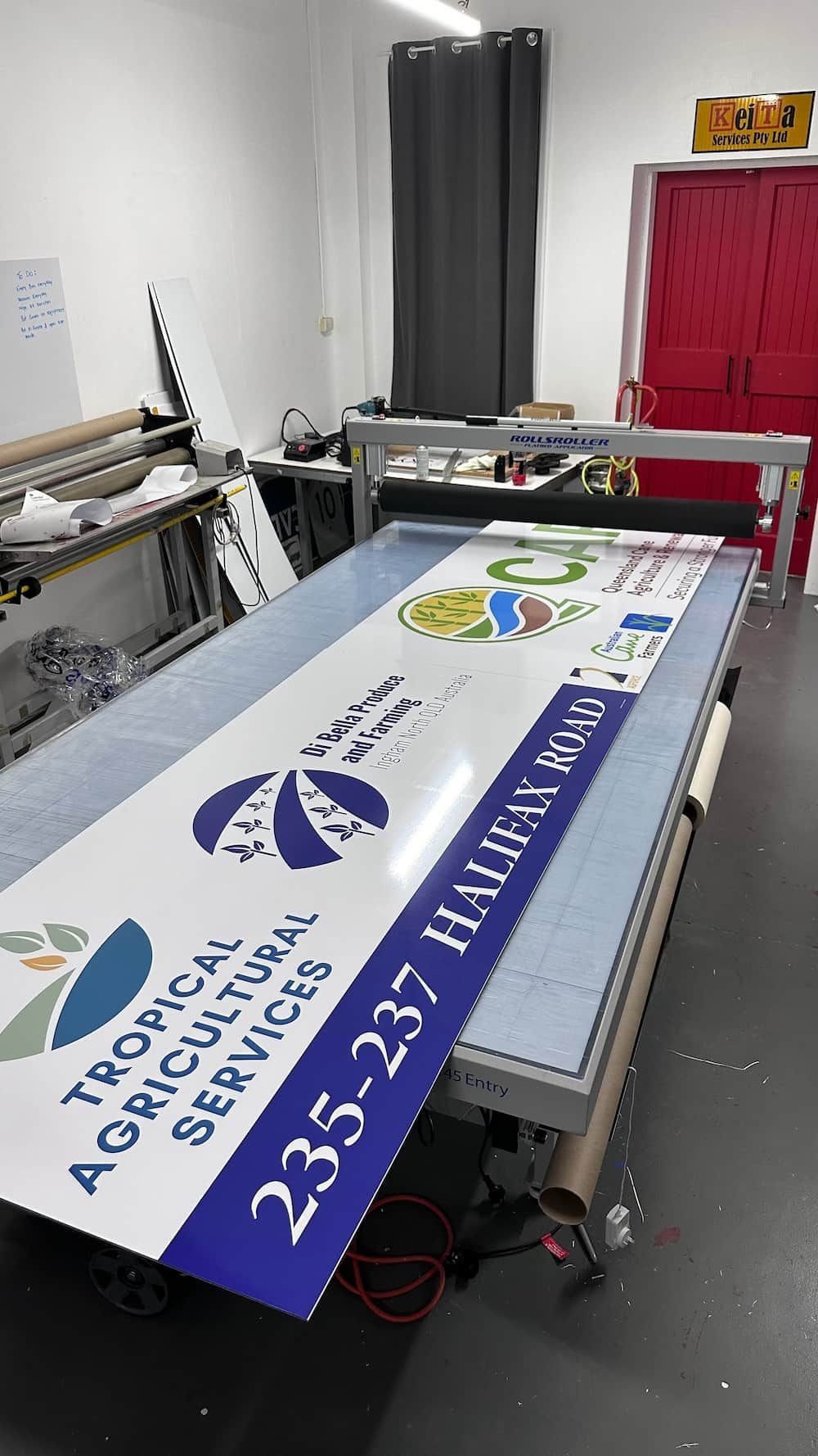 A Large Sign is Sitting on Top of a Table in a Room — Global Signage In Ingham, QLD