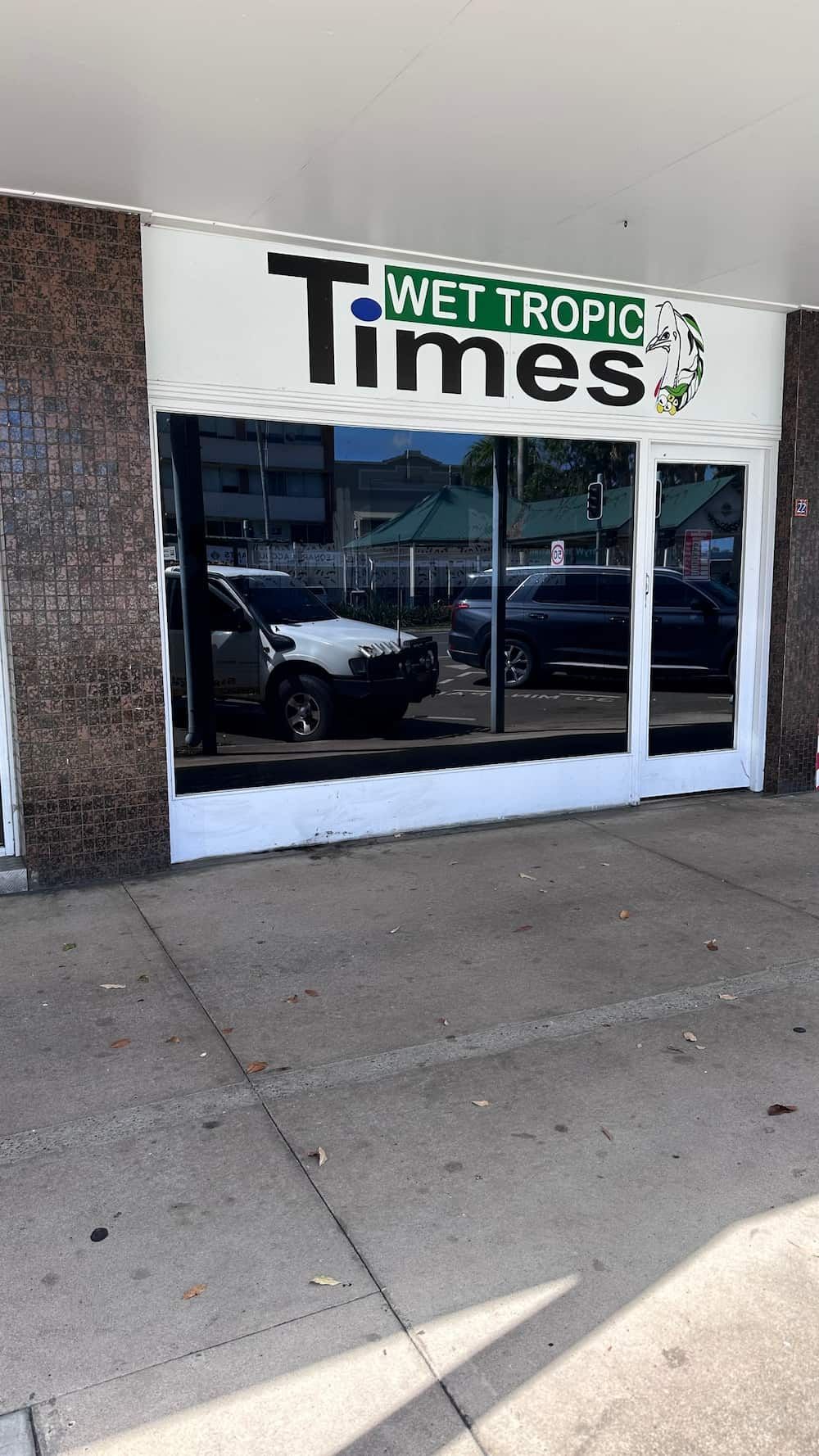 A Wet Tropic Times Store Front With Cars Parked in Front of It — Global Signage In Ingham, QLD