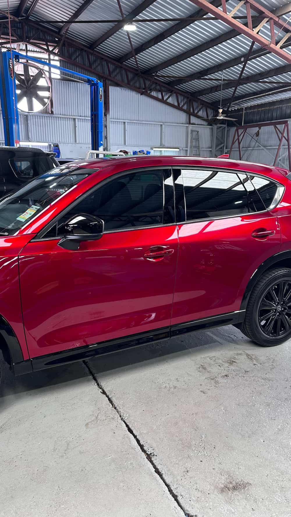 A Red Car is Parked in a Garage — Global Signage In Ingham, QLD