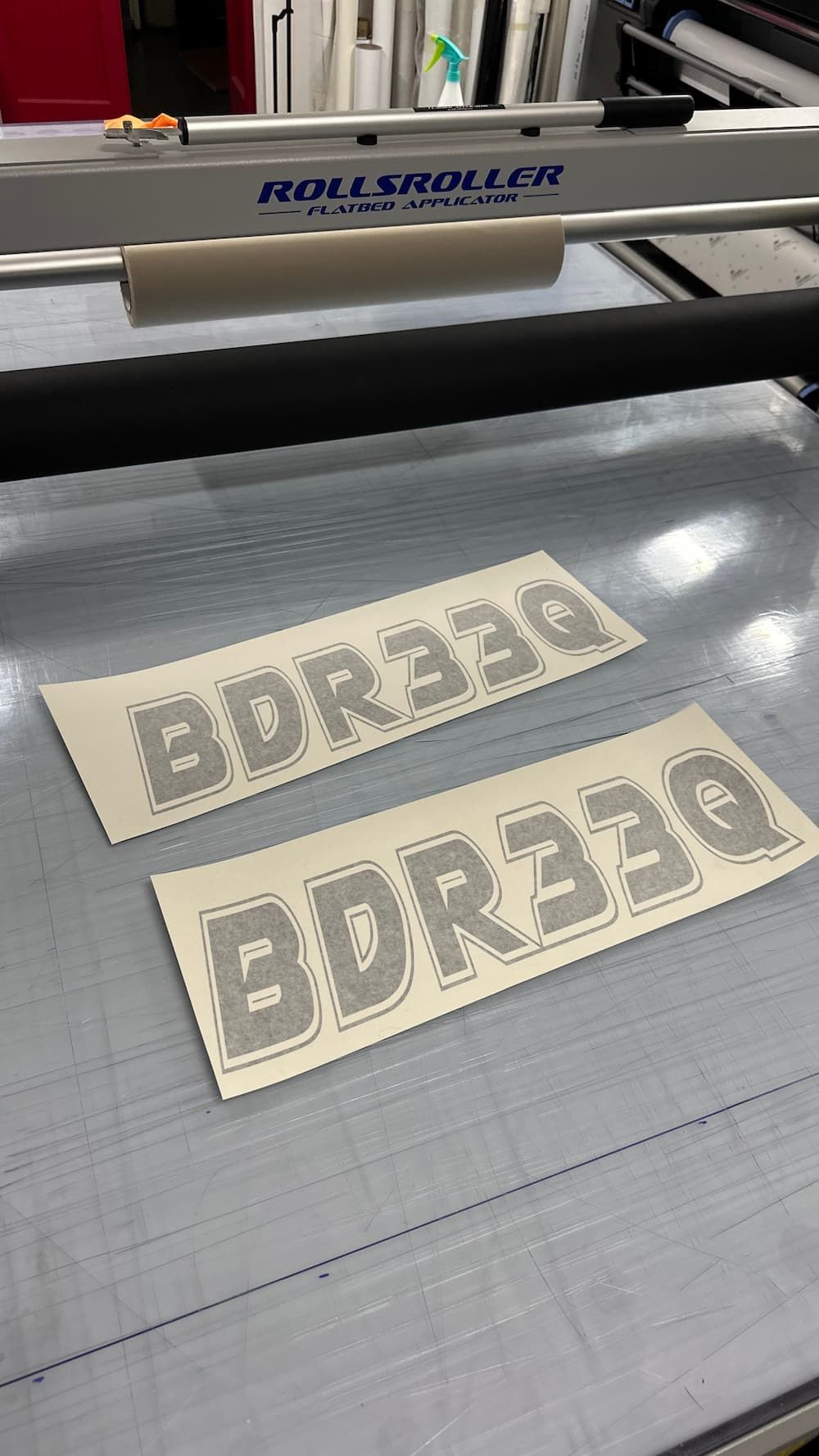 A Machine is Cutting a Piece of Paper With the Word Edr330 on It — Global Signage In Ingham, QLD