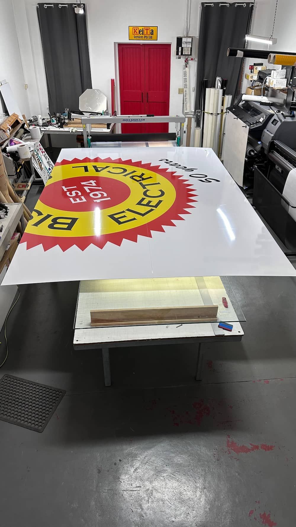 A Large Sign is Sitting on Top of a Table in a Room — Global Signage In Ingham, QLD