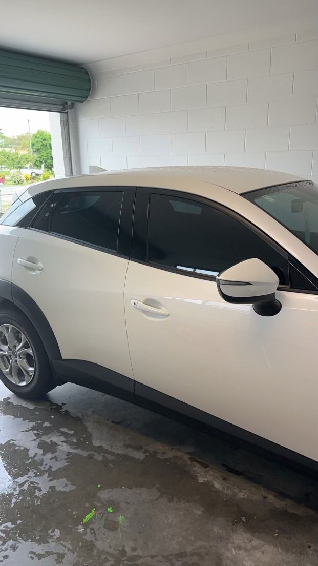 A White Car is Parked in a Garage — Global Signage In Ingham, QLD