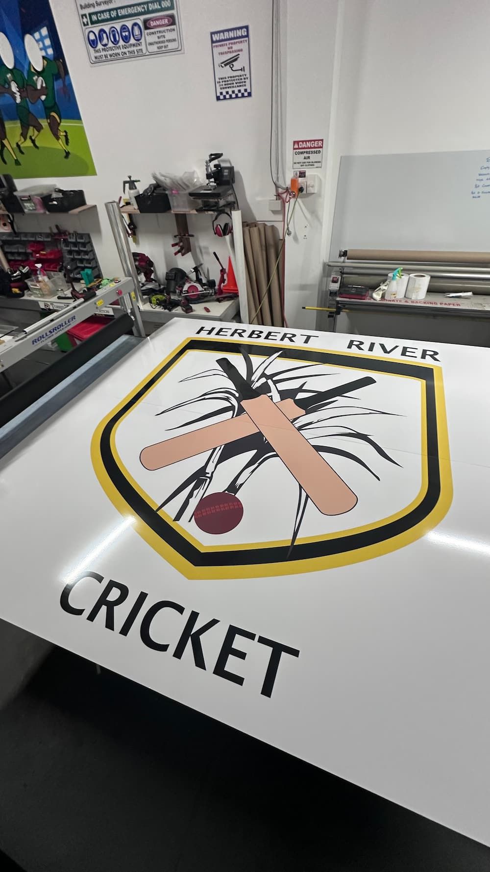 A Cricket Logo is Sitting on Top of a Table in a Room — Global Signage In Ingham, QLD