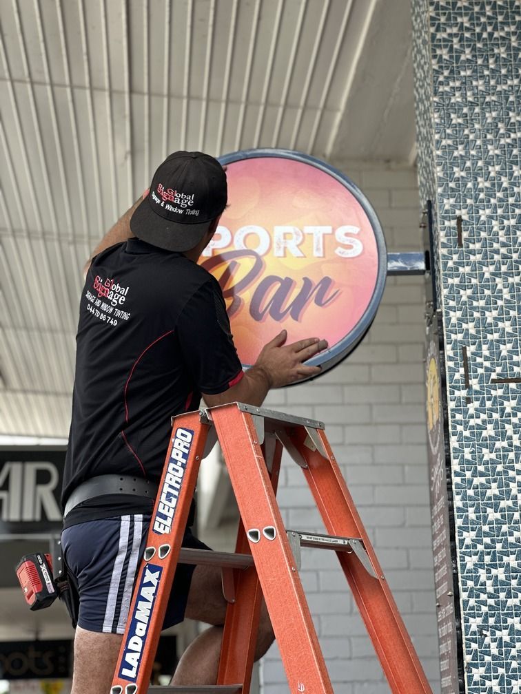 Two Signs For The Queensland Ambulance Service Are Sitting On A Table — Global Signage In Ingham, QLD
