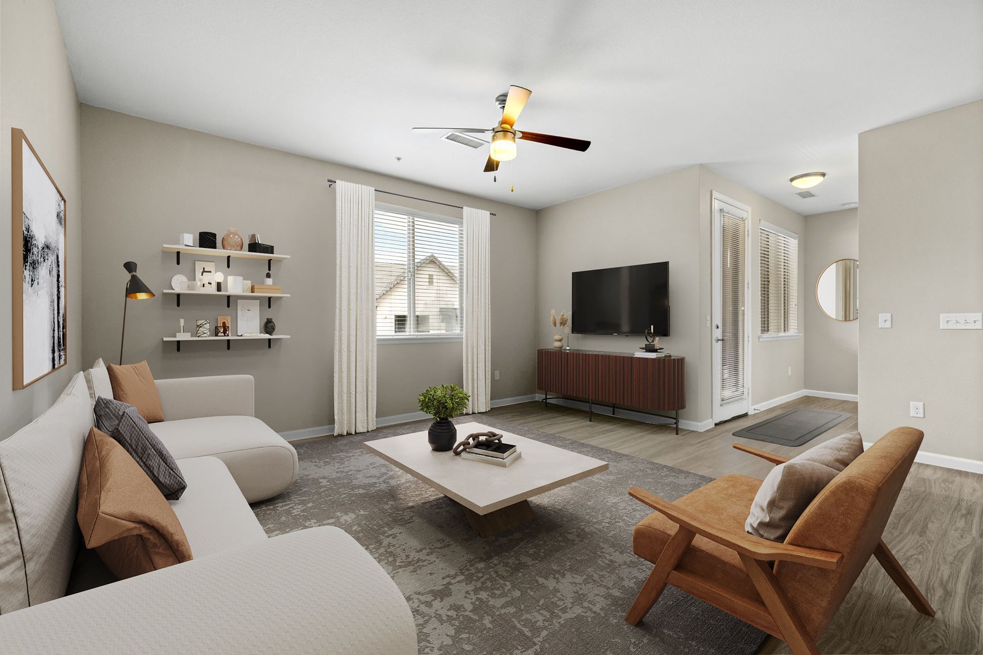 Living room with beige walls, white sofa, brown chair, coffee table, and TV.